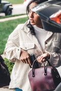 Woman drawing handgun from bag