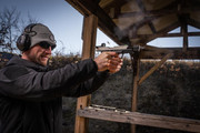 Professional testing - shooter firing handgun at range